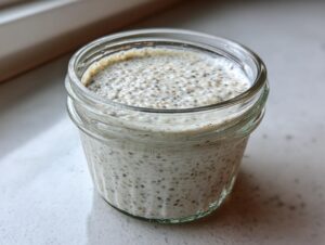 Close-up of creamy, thick chia pudding made with 5 ingredients, set in a small glass jar.