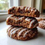 Close-up of three stacked coffee cake cookies with a thick, drizzled vanilla glaze.