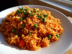 A close-up of fluffy, bright orange Mexican rice mixed with green peas and topped with fresh cilantro.