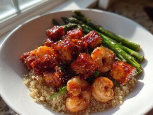 Close-up of a vibrant tofu and shrimp protein bowl served over quinoa with asparagus spears.